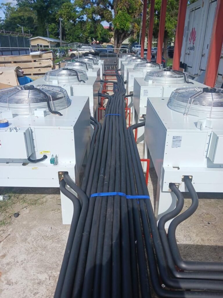 Row of VRF outdoor condensing units with insulated refrigerant lines, National Data Management Authority installation